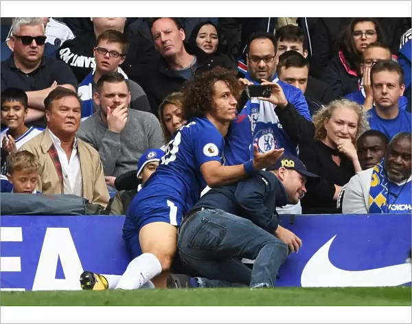 David Luiz's Unusual Opponent: Fan Collision at Stamford Bridge During Chelsea vs Arsenal Match