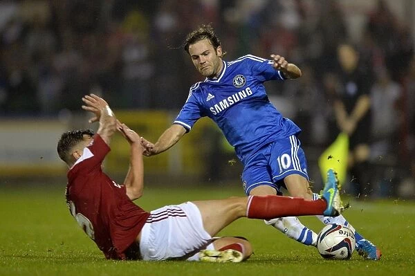 Battle for the Ball: Juan Mata vs. Grant Hall - Swindon Town's Courageous Stand against Chelsea