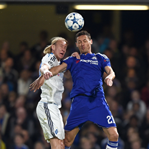 Clash at Stamford Bridge: Aerial Battle between Chelsea's Nemanja Matic and Dynamo Kiev's Domagoj Vida in the UEFA Champions League