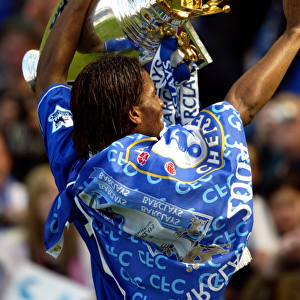 Didier Drogba's Triumph: Celebrating Chelsea's Premier League Victory with the FA Barclays Trophy at Stamford Bridge (2004-2005)
