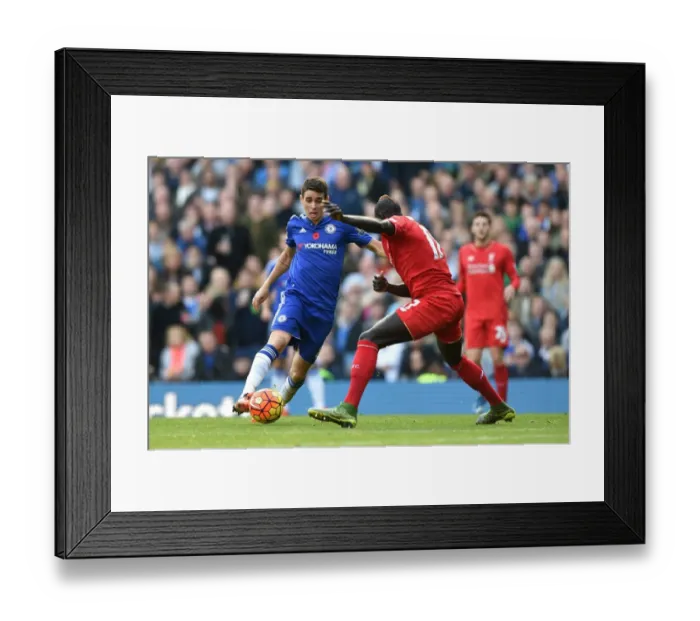 Framed Print : Intense Rivalry: Oscar vs Sakho's Battle for Ball Supremacy at Stamford Bridge