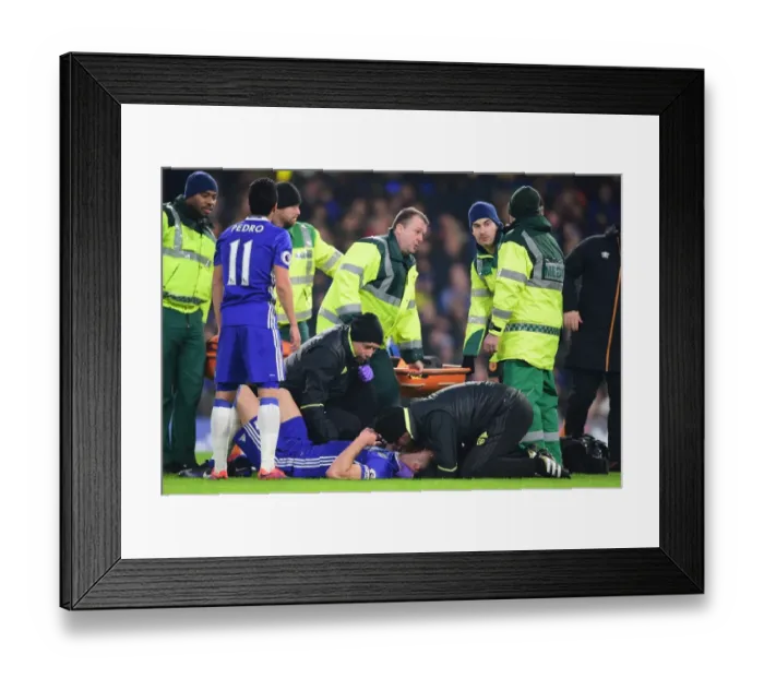 Framed Print : Chelsea's Gary Cahill Receives Medical Treatment After Collision with Hull City's Ryan Mason