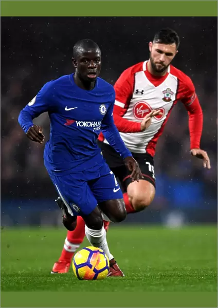 Chelsea's N'Golo Kante Outmaneuvers Southampton's Charlie Austin during Premier League Clash at Stamford Bridge