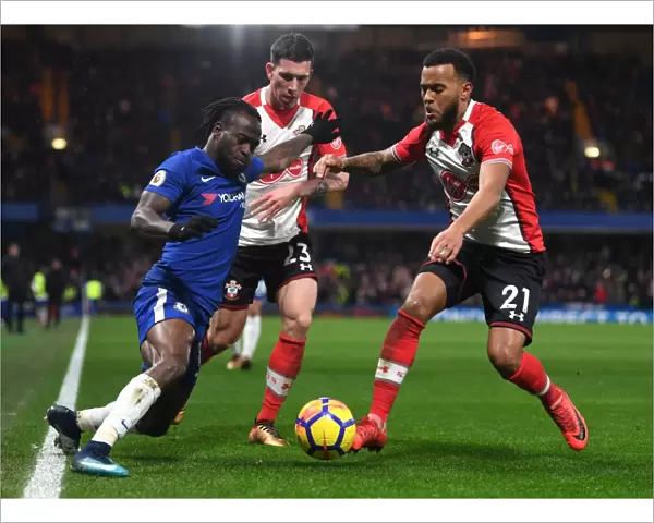 Intense Battle for Possession: Chelsea's Victor Moses vs. Southampton's Ryan Bertrand and Pierre-Emile Hojbjerg