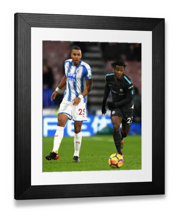 Framed Print : Michy Batshuayi vs. Mathias Jorgensen: Intense Battle in Huddersfield Town vs. Chelsea Premier League Clash