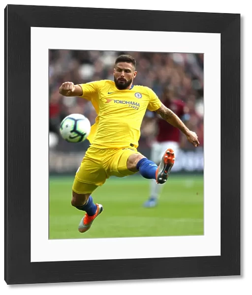Chelsea's Olivier Giroud Reaches for the Ball in Intense West Ham Clash