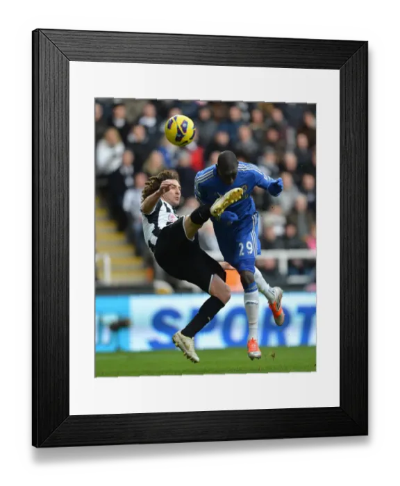 Framed Print : Clash at St. James Park: Demba Ba vs. Coloccini - A Rough Premier League Encounter between Newcastle and Chelsea