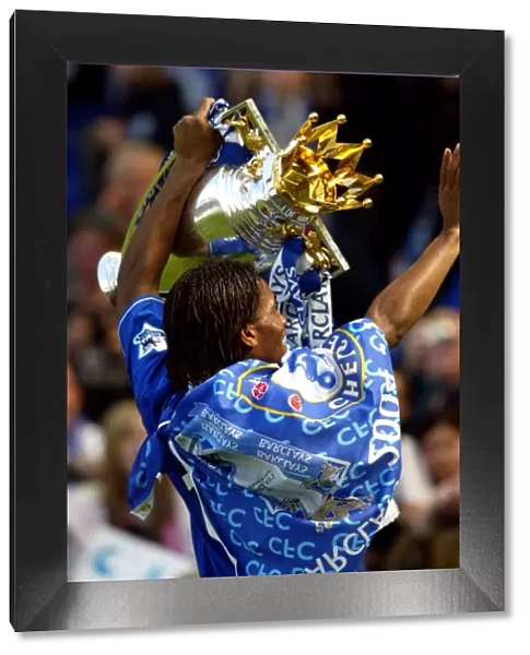 Didier Drogba's Triumph: Celebrating Chelsea's Premier League Victory with the FA Barclays Trophy at Stamford Bridge (2004-2005)