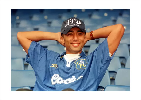 1025941. New Chelsea signing Roberto di Matteo smiles for the cameras after