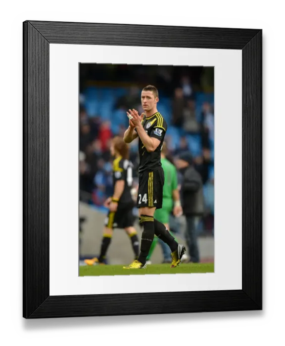 Framed Print : Gary Cahill vs Manchester City: Intense Face-off in Premier League Clash