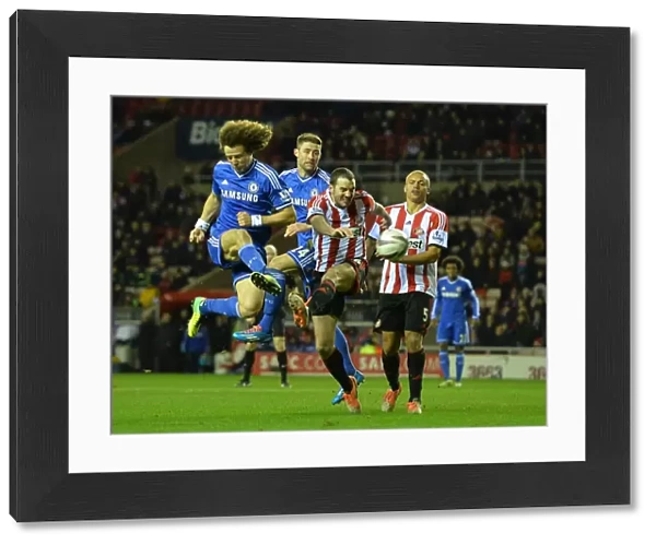 David Luiz and Gary Cahill vs. John O'Shea and Wes Brown: A Battle for the Ball in the Intense Capital One Cup Quarterfinal at Stadium of Light (December 17, 2013)