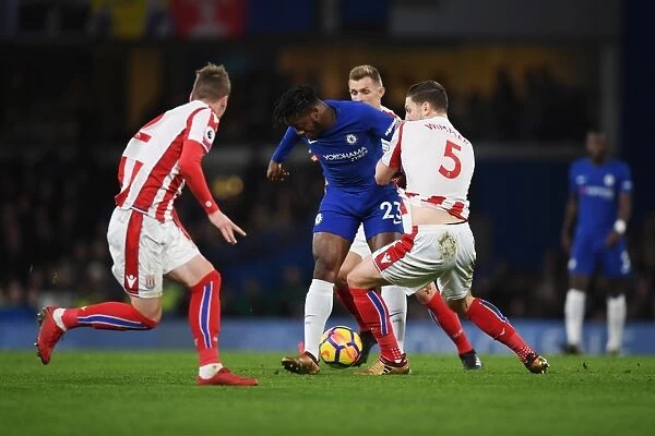 Batshuayi vs. Wimmer: Intense Battle for Possession in Chelsea vs. Stoke City Premier League Showdown