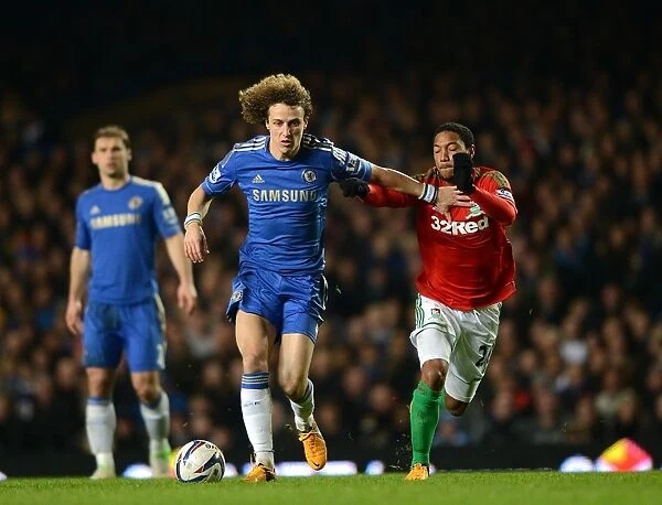 David Luiz vs. Jonathan de Guzman: A Fierce Battle for Ball Possession in the Chelsea vs. Swansea Capital One Cup Semi-Final (January 9, 2013)