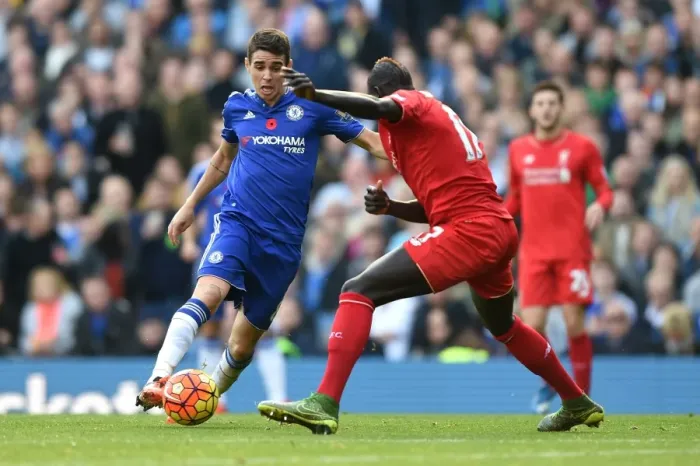 Framed Print : Intense Rivalry: Oscar vs Sakho's Battle for Ball Supremacy at Stamford Bridge