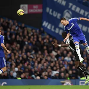 Aerial Clash at Stamford Bridge: Terry vs. Sissoko - Premier League Battle between Chelsea and Newcastle United (10th January 2015)