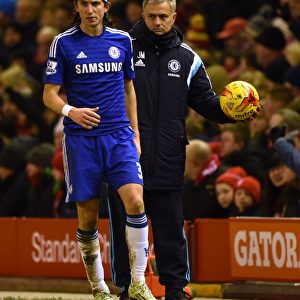 Jose Mourinho's Unwavering Focus: Chelsea Manager Holds the Ball Amidst the Intense Semi-Final Clash with Liverpool in Capital One Cup (Liverpool v Chelsea, 20th January 2015)