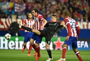Images Dated 22nd April 2014: Battle for the Ball: Diego Godin vs. Fernando Torres in the Intense UEFA Champions League