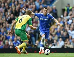 Chelsea v Norwich City 4th May 2014 Collection: Battle for the Ball: John Terry vs. Michael Turner - Chelsea vs