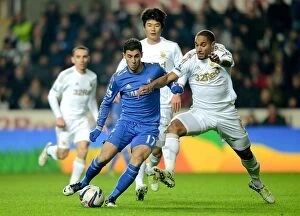 Images Dated 23rd January 2013: Battle for Ball Supremacy: Eden Hazard vs. Ashley Williams in the Intense Chelsea-Swansea League