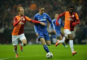 Images Dated 26th February 2014: Battle for the Ball: Torres Sandwiched between Kaya and Chedjou in Intense UEFA Champions League
