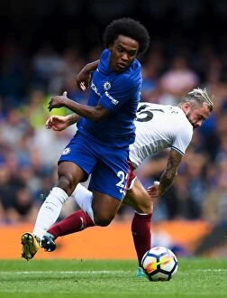 Images Dated 12th August 2017: Battle for Possession: Willian vs. Steven Defour - Premier League Showdown at Stamford Bridge