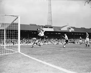 Chelsea vs. Burnley: Intense Moment as Mel Scott Ducks and Reg Matthews Clears the Ball from Ray Pointer