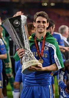 Chelsea v Benfica 16th May 2013 Europa Cup Final Collection: Chelsea's Oscar Lifts the Europa League Trophy: Chelsea FC Victory over Benfica (Amsterdam Arena)