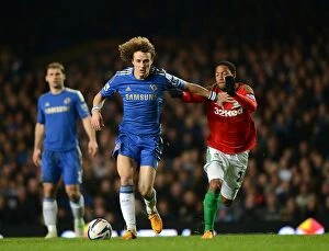 Images Dated 9th January 2013: David Luiz vs. Jonathan de Guzman: A Fierce Battle for Ball Possession in the Chelsea vs