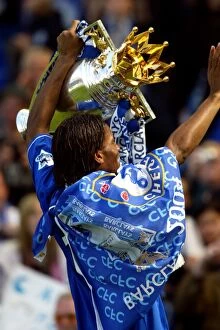 Premier League Winners 2004-2005 Collection: Didier Drogba's Triumph: Celebrating Chelsea's Premier League Victory with the FA Barclays Trophy