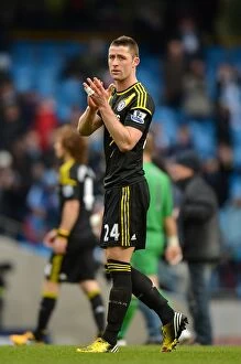 Images Dated 24th February 2013: Gary Cahill vs Manchester City: Intense Face-off in Premier League Clash