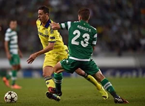 Images Dated 30th September 2014: Nemanja Matic vs. Adrien Silva: A Battle for Ball Possession in Chelsea's UEFA Champions League